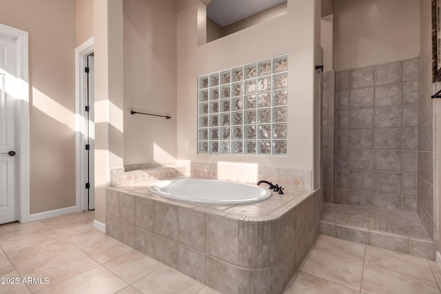 full bath with a tile shower, tile patterned flooring, and a bath