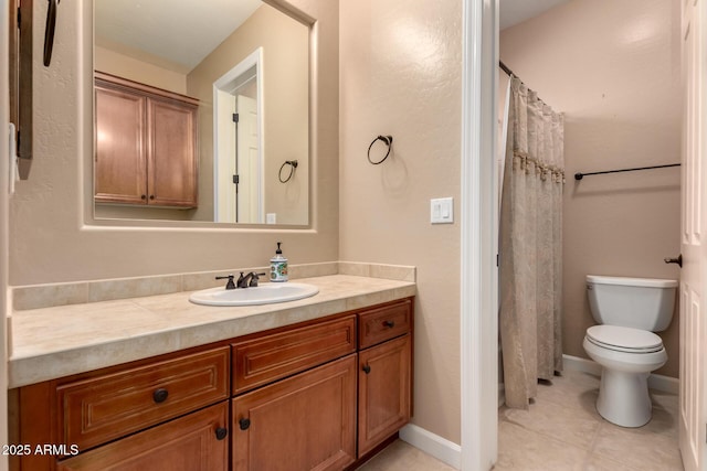 bathroom featuring tile patterned flooring, baseboards, vanity, and toilet