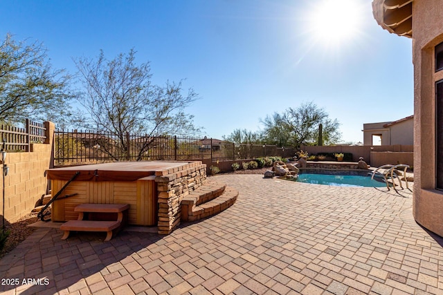 view of swimming pool with a patio, a fenced backyard, a fenced in pool, and a hot tub