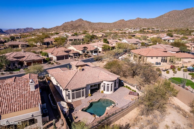 drone / aerial view featuring a residential view and a mountain view