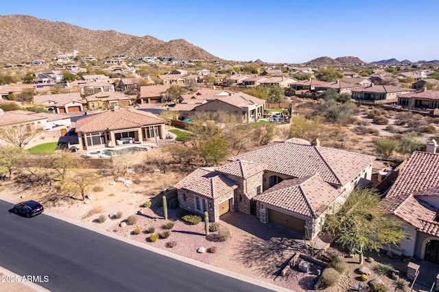 drone / aerial view featuring a residential view and a mountain view