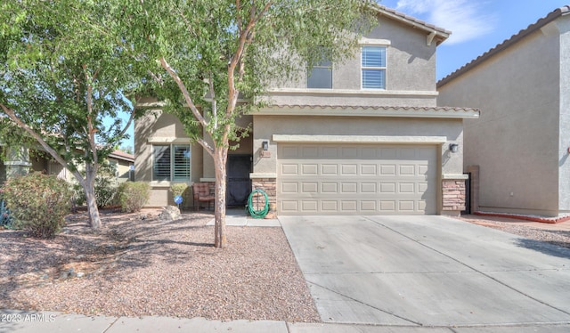 view of front of property with a tile roof, stucco siding, a garage, and concrete driveway