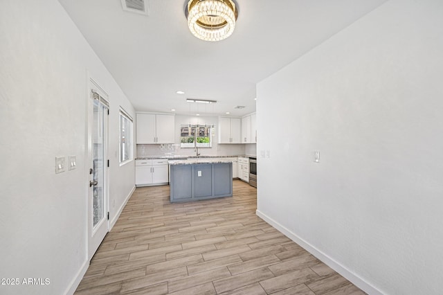 1017 S Allen, Mesa, AZ 85204 - kitchen with white cabinets, light wood finished floors, a center island, a chandelier, and recessed lighting