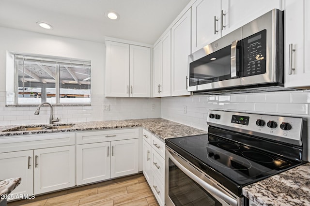 1017 S Allen, Mesa, AZ 85204 - kitchen featuring stainless steel appliances, white cabinets, decorative backsplash, light stone countertops, and recessed lighting