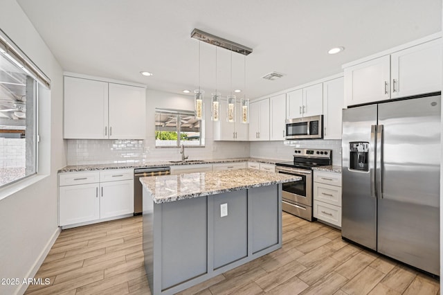1017 S Allen, Mesa, AZ 85204 - kitchen with stainless steel appliances, tasteful backsplash, white cabinetry, and recessed lighting