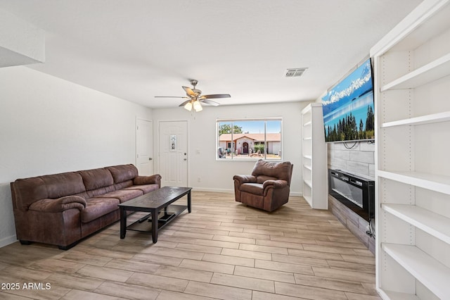 1017 S Allen, Mesa, AZ 85204 - living room with a tile fireplace, light wood finished floors, and a ceiling fan