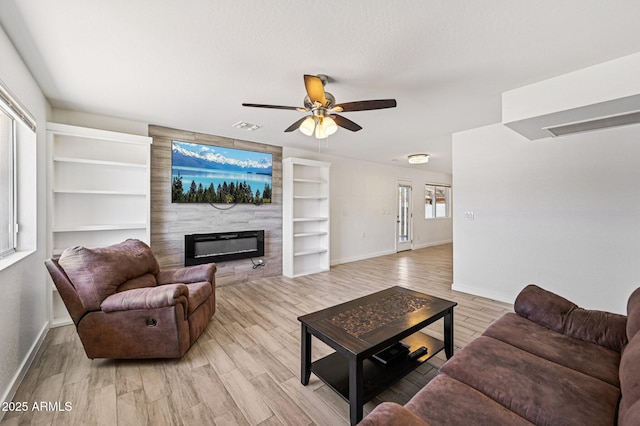 1017 S Allen, Mesa, AZ 85204 - living room featuring ceiling fan, a fireplace, light wood-style floors, and built in shelves