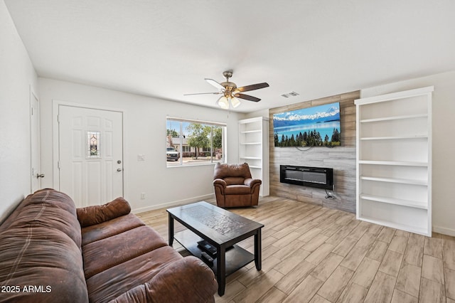 1017 S Allen, Mesa, AZ 85204 - living room with a fireplace, ceiling fan, built in shelves, and wood finished floors