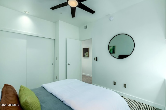 bedroom featuring ceiling fan, carpet floors, and a closet