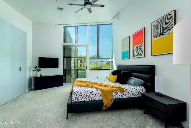 carpeted bedroom featuring expansive windows