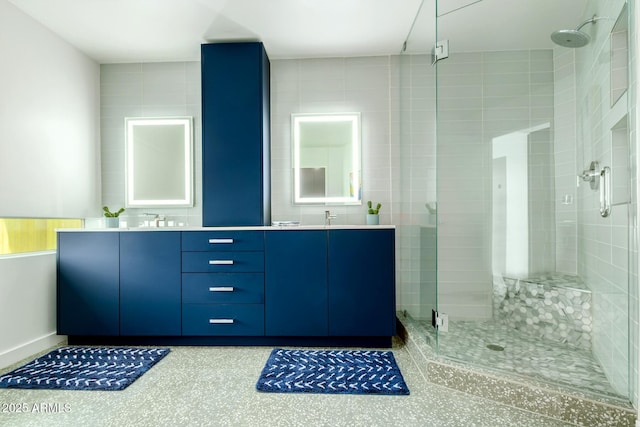 bathroom featuring vanity and a shower with door