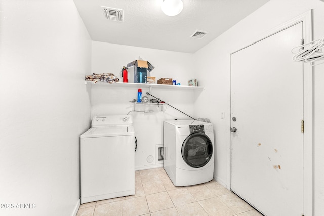 laundry room featuring light tile patterned flooring and washer and dryer