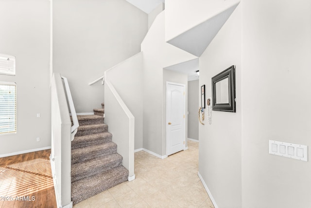 stairs featuring a towering ceiling