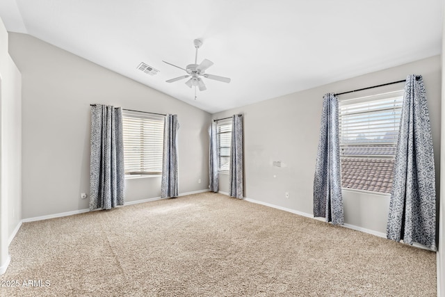 carpeted spare room with vaulted ceiling and ceiling fan