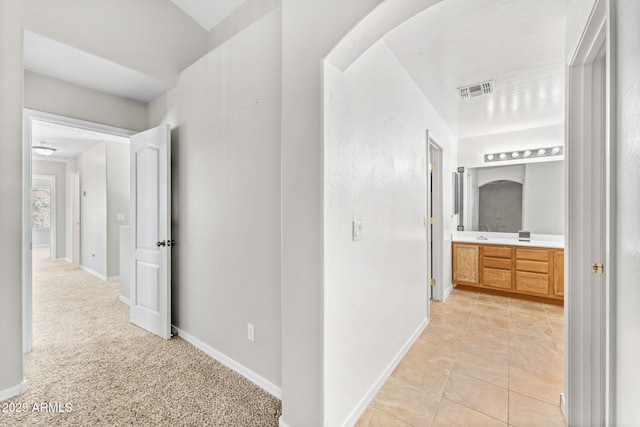 corridor featuring light tile patterned flooring