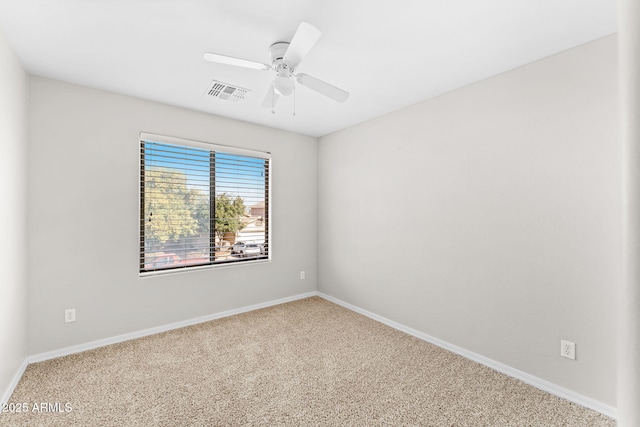 spare room featuring carpet and ceiling fan