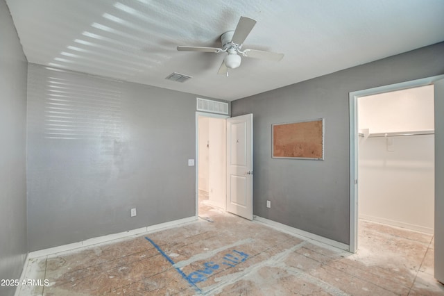 bedroom featuring ceiling fan, a walk in closet, and a closet