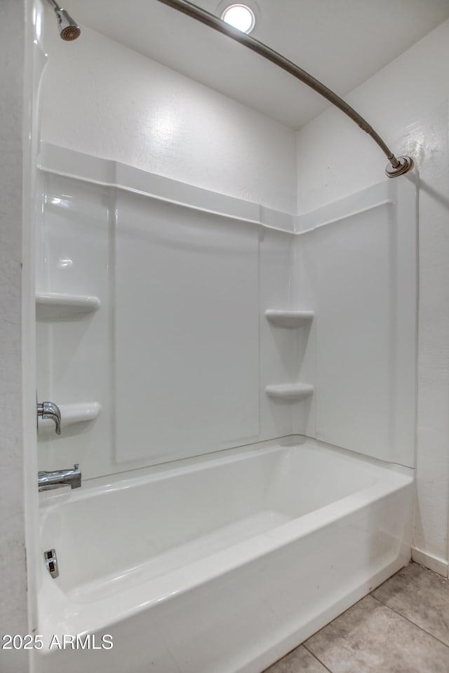 bathroom featuring tile patterned flooring and bathtub / shower combination