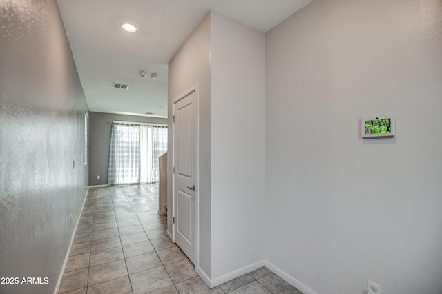 hall featuring light tile patterned floors