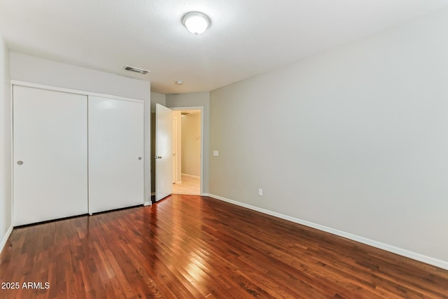 1048 N Arroya, Mesa, AZ 85205 - unfurnished bedroom featuring wood finished floors and a closet