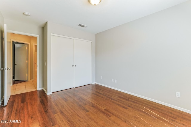 1048 N Arroya, Mesa, AZ 85205 - unfurnished bedroom with wood finished floors and a closet