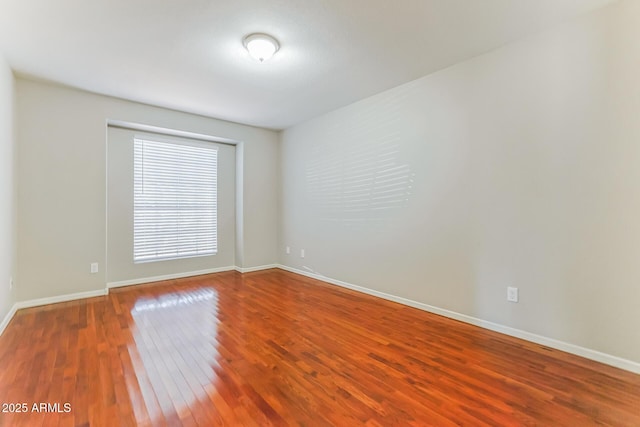 1048 N Arroya, Mesa, AZ 85205 - spare room with wood-type flooring and baseboards