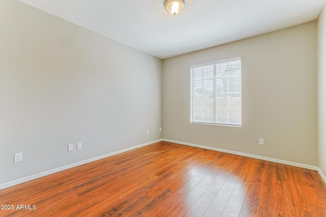 1048 N Arroya, Mesa, AZ 85205 - spare room featuring baseboards and wood finished floors