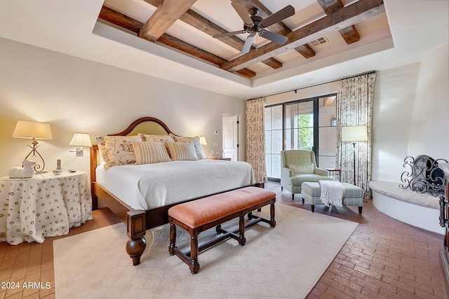 bedroom with a raised ceiling, beamed ceiling, and ceiling fan