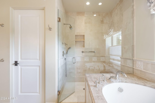 bathroom featuring sink and shower with separate bathtub