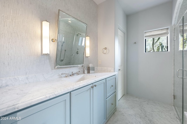 bathroom featuring walk in shower and vanity