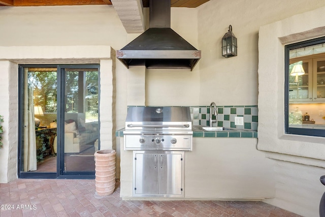 view of patio with an outdoor kitchen, sink, and grilling area