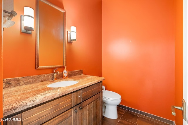 bathroom featuring vanity, tile patterned flooring, and toilet