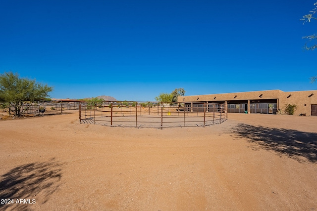 view of yard with an outbuilding and a rural view