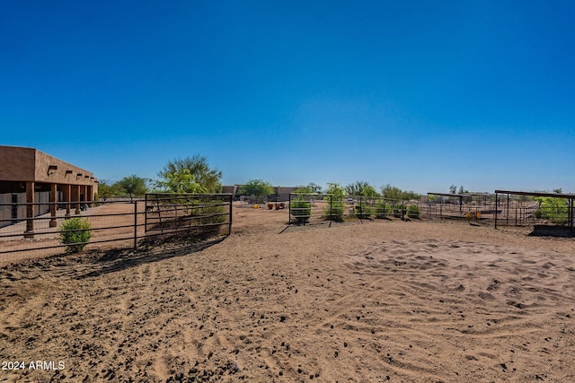 view of yard with an outdoor structure and a rural view