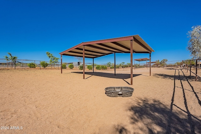 surrounding community featuring an outdoor fire pit