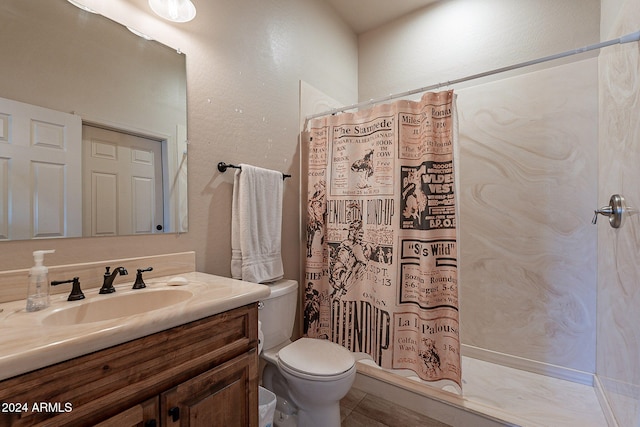 bathroom with toilet, a shower with curtain, vanity, and tile patterned floors