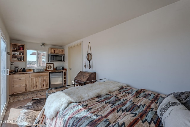 bedroom with stainless steel refrigerator