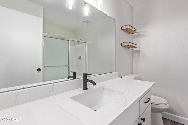 11671 S Jokake St, Phoenix, AZ 85044 - full bathroom featuring toilet, vanity, a shower with shower door, wood finished floors, and baseboards