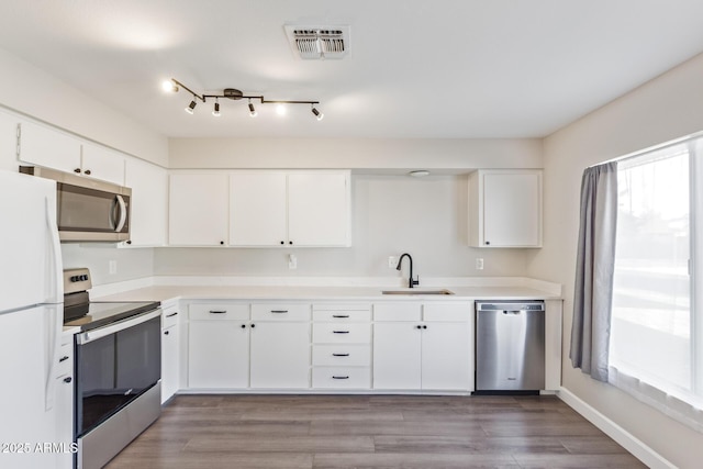 11671 S Jokake St, Phoenix, AZ 85044 - kitchen with appliances with stainless steel finishes, a sink, white cabinetry, and light countertops