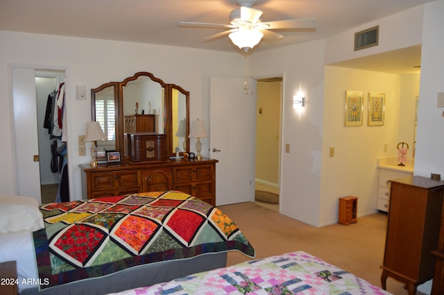 carpeted bedroom with ceiling fan and ensuite bathroom