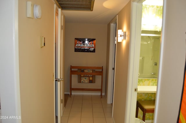 corridor featuring light tile patterned floors