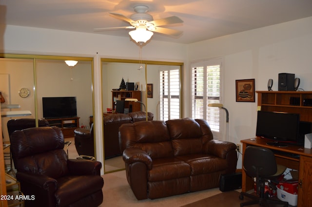 living room featuring light colored carpet and ceiling fan