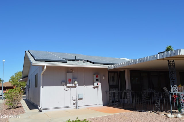 view of front facade featuring solar panels