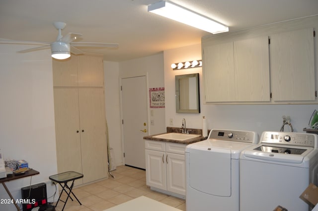 washroom featuring cabinets, sink, ceiling fan, washing machine and dryer, and light tile patterned floors