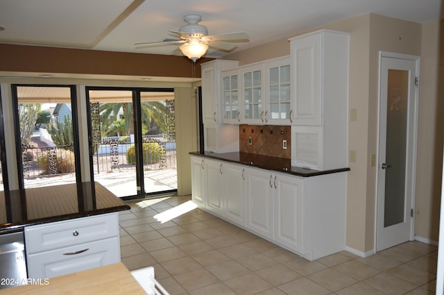 kitchen with white cabinets, light tile patterned floors, decorative backsplash, and ceiling fan