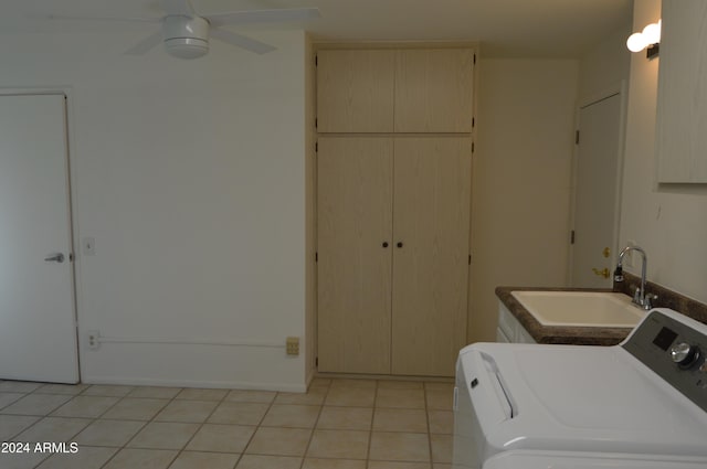 laundry area with ceiling fan, sink, and light tile patterned floors