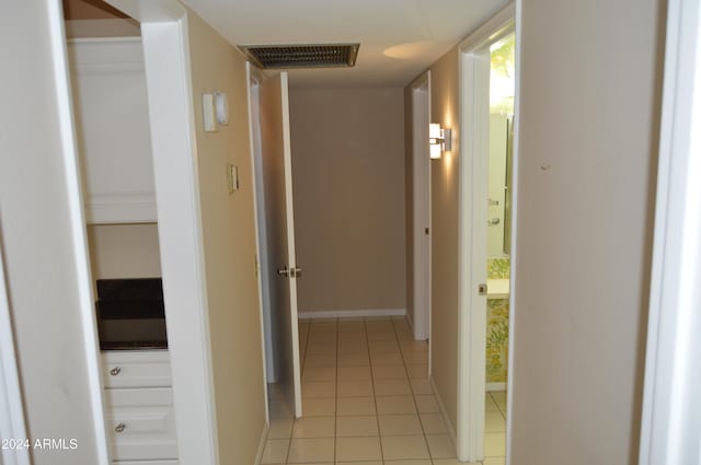 hall featuring light tile patterned flooring