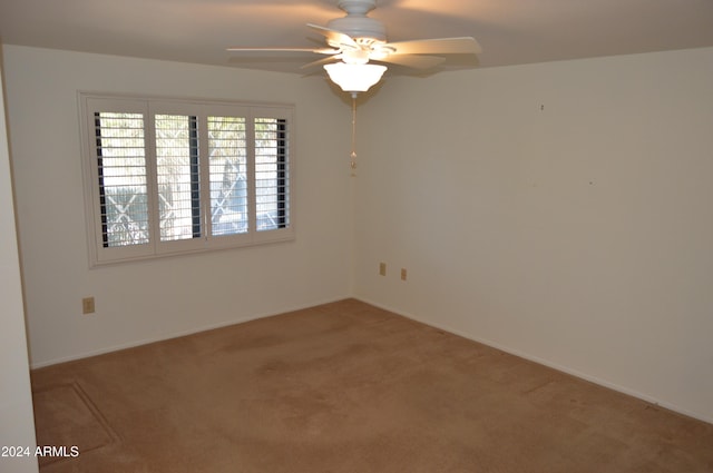 empty room with carpet flooring and ceiling fan