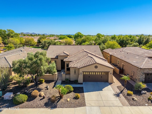 27789 N 129th Ln, Peoria, AZ 85383 - view of front facade with fence, an attached garage, stucco siding, a tiled roof, and driveway