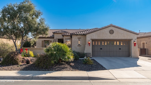 mediterranean / spanish-style home with a garage